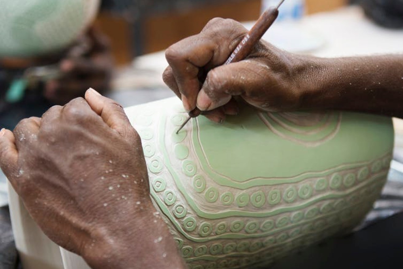  Alison Milyika Carroll working on a pot at Ernabella Arts ceramic studio. Photo courtesy of Sabbia Gallery