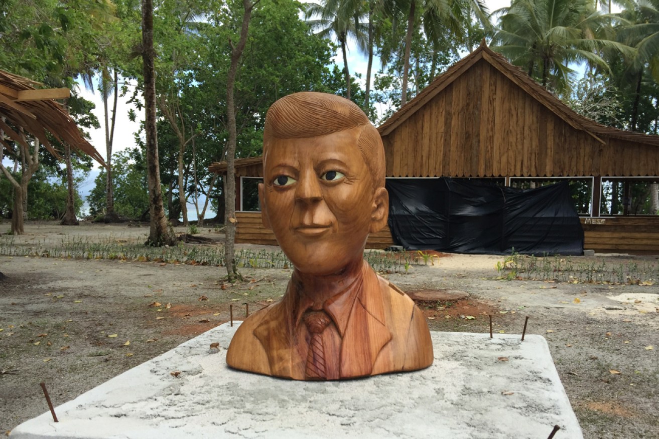 A wooden carving of John F Kennedy on Lubaria Island. Photo: Michael Wayne / AAP