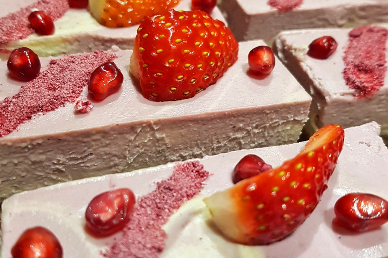 A strawberry-topped slice by Raw Earth Desert.