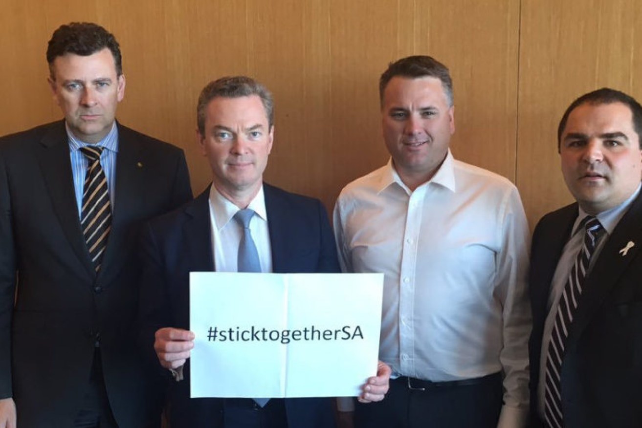 STICKING TOGETHER? Christopher Pyne (holding sign) and Barker MP Tony Pasin (right), with then-MPs Andrew Southcott and Jamie Briggs in 2015. Photo: Twitter