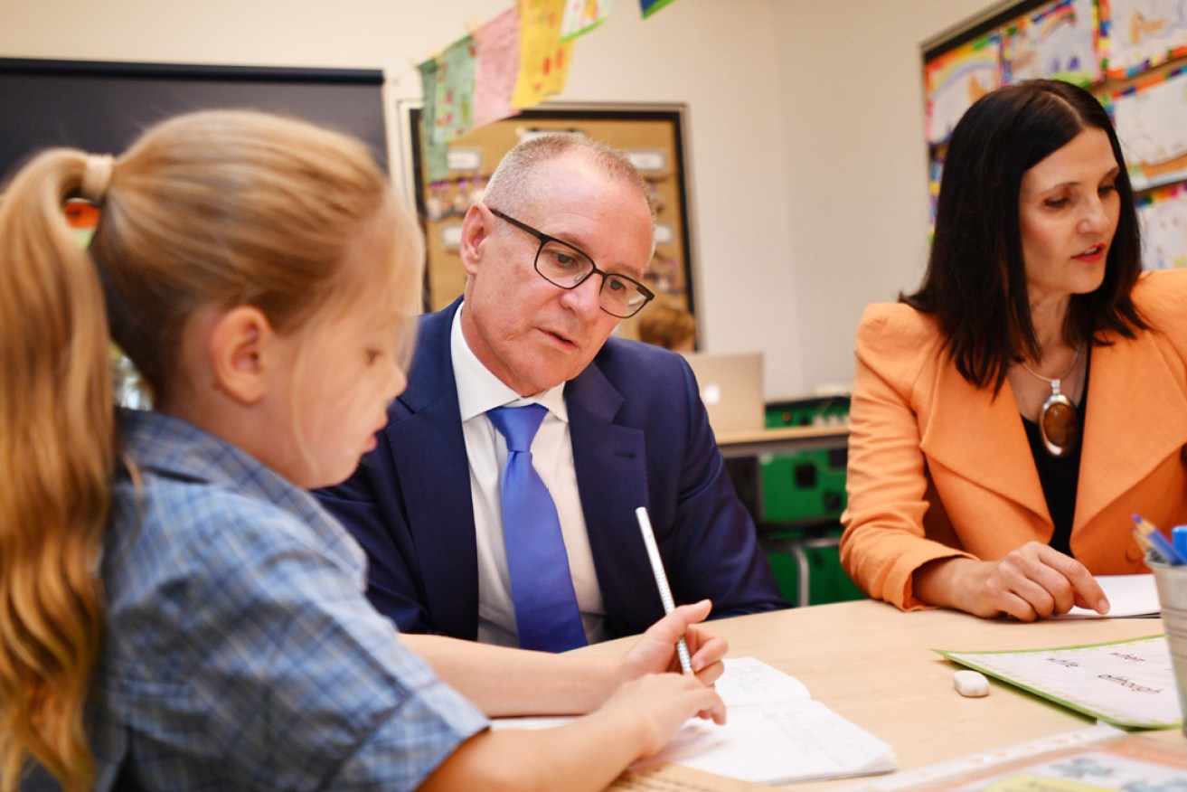 Premier Jay Weatherill and Labor candidate for Adelaide Joe Chapley with children at Rosary Catholic School in Prospect. Photo: AAP / David Mariuz