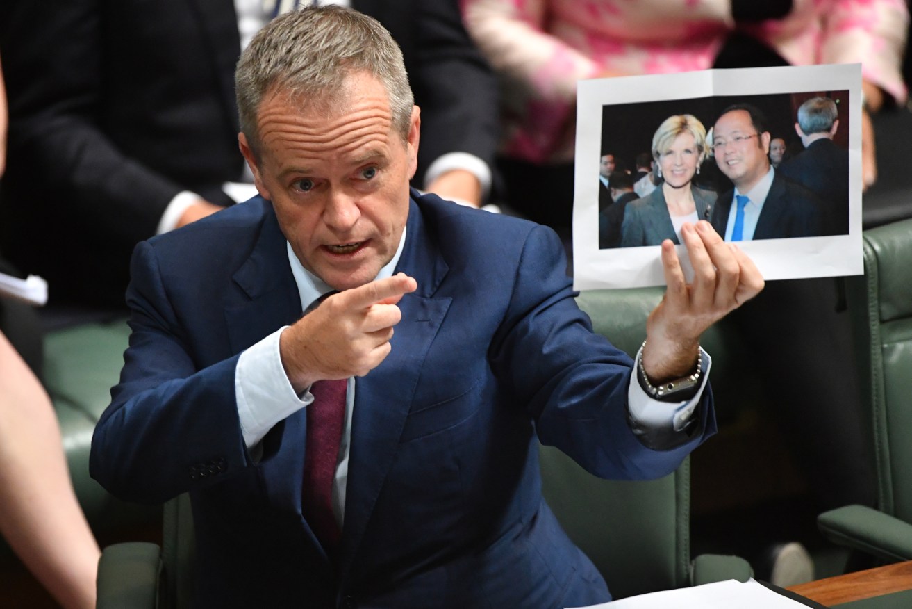 Earlier this year, Opposition Leader Bill Shorten produced a photograph of Minister for Foreign Affairs Julie Bishop and Chinese businessman Huang Xiangmo during Question Time. Photo: AAP/Mick Tsikas