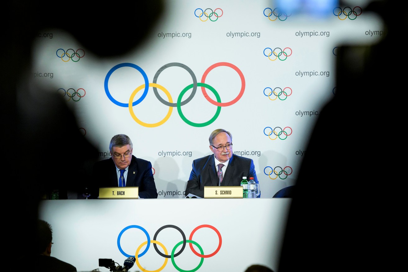 IOC President Thomas Bach and Samuel Schmid, President of the IOC Inquiry Commission and former President of Switzerland, face media overnight, Australian time. Photo: JEAN-CHRISTOPHE BOTT / EPA