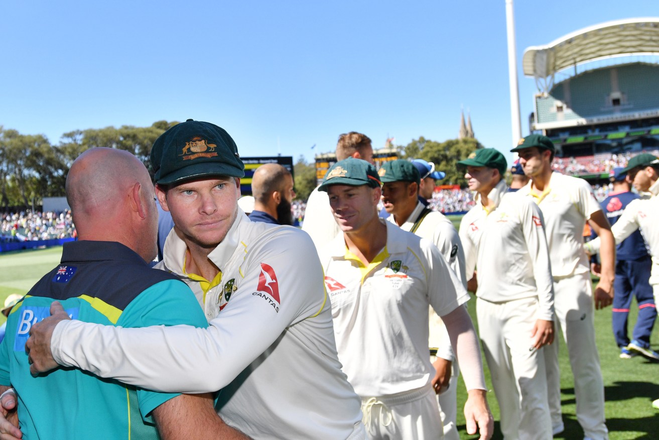 A resolute Steve Smith embraces Darren Lehmann after victory in the Adelaide Test. Photo: David Mariuz / AAP