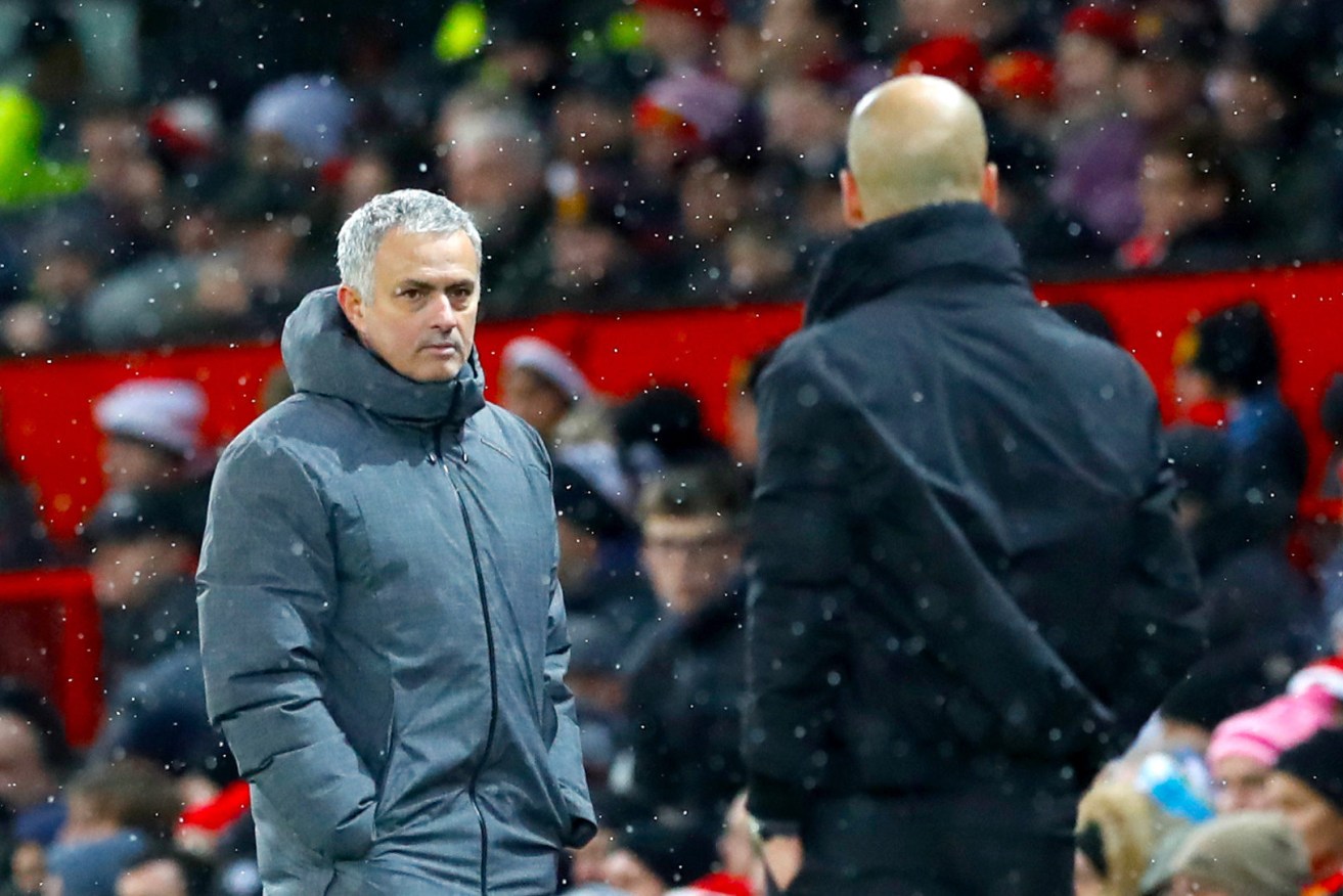 Manchester United manager Jose Mourinho City boss Pep Guardiola cross paths on the touchline. Photo: Martin Rickett / PA Wire