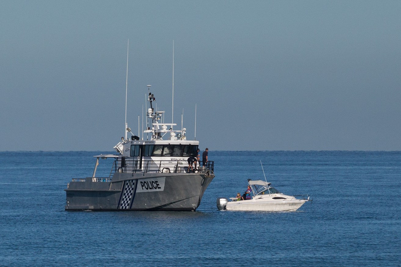 Police divers search for the missing teenage girl off  Glenelg Beach earlier today. Photo: AAP/Ben Macmahon