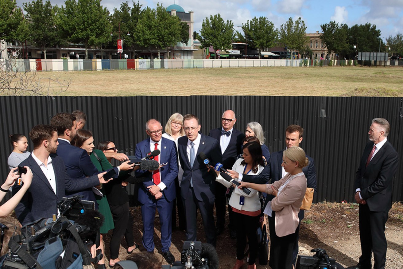Lord Mayor Martin Haese (centre) addressing reporters in December, in front of the long-vacant former Le Cornu site, flanked by Premier Jay Weatherill (left) and city councillors. Photo: Tony Lewis / InDaily