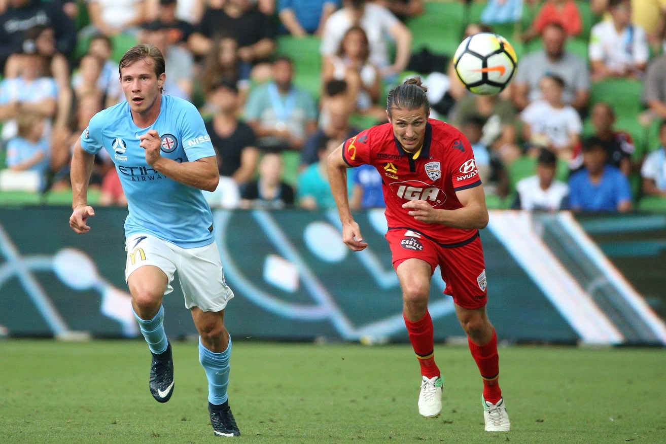 United's Michael Marrone (right) under pressure from Melbourne City's Nick Fitzgerald. Photo: AAP/Hamish Blair
