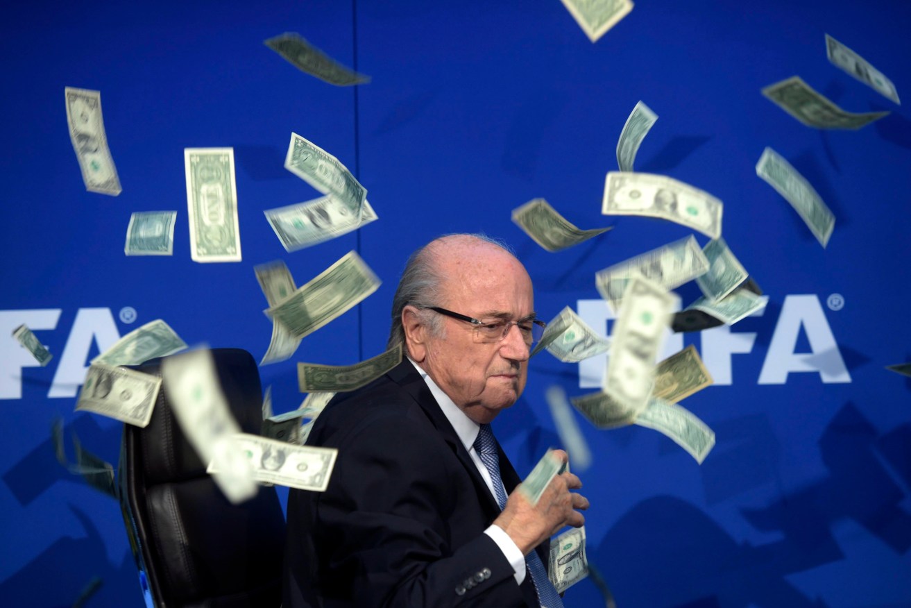 Sepp Blatter in a shower of banknotes thrown by a British comedian. He never thought Australia had a chance of winning hosting rights for the FIFA World Cup. Photo: Ennio Leanza/Keystone via AP