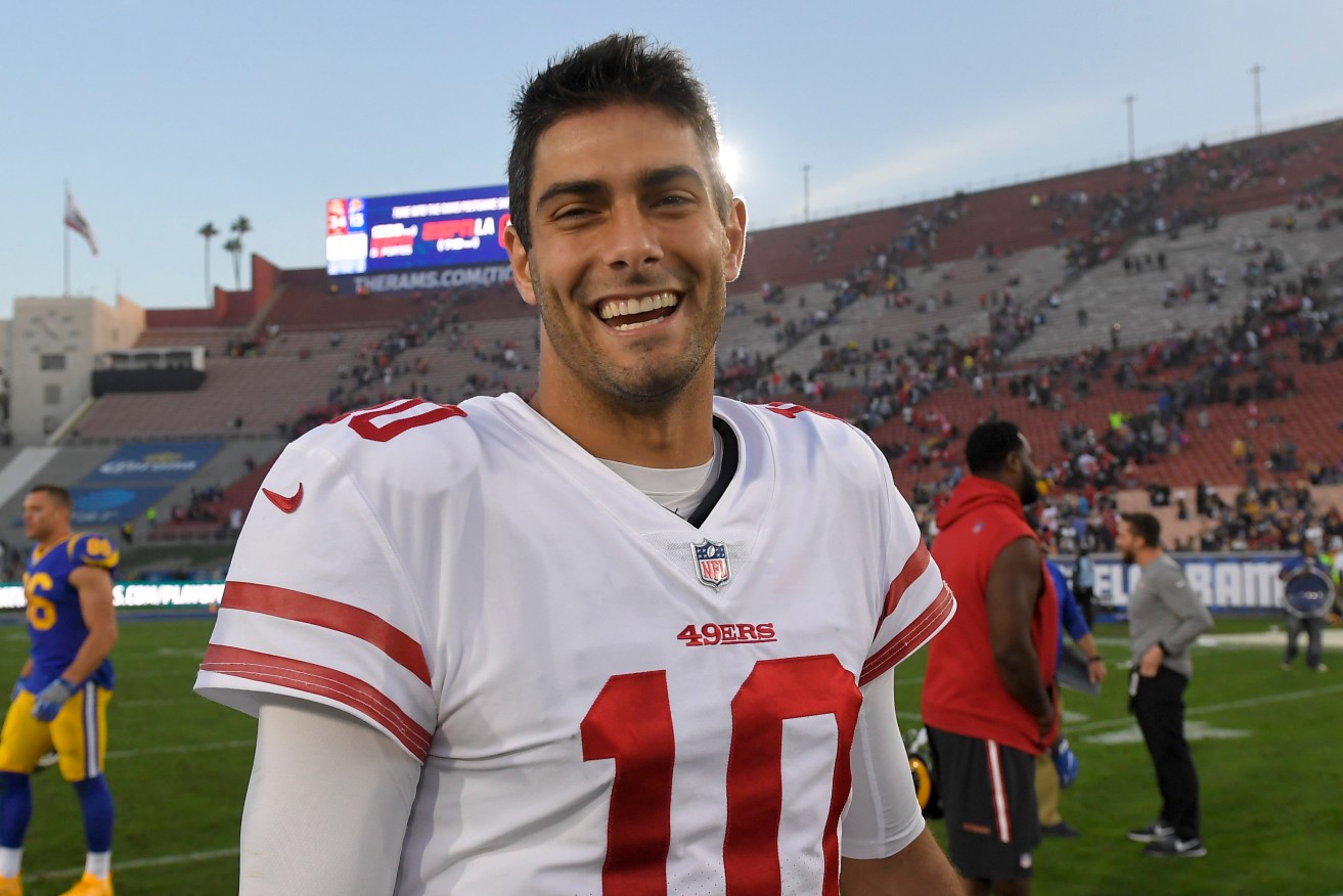 Well may he smile -  49ers quarterback Jimmy Garoppolo has just signed a five-year $137.5 million deal. Photo: AP/Mark J. Terrill
