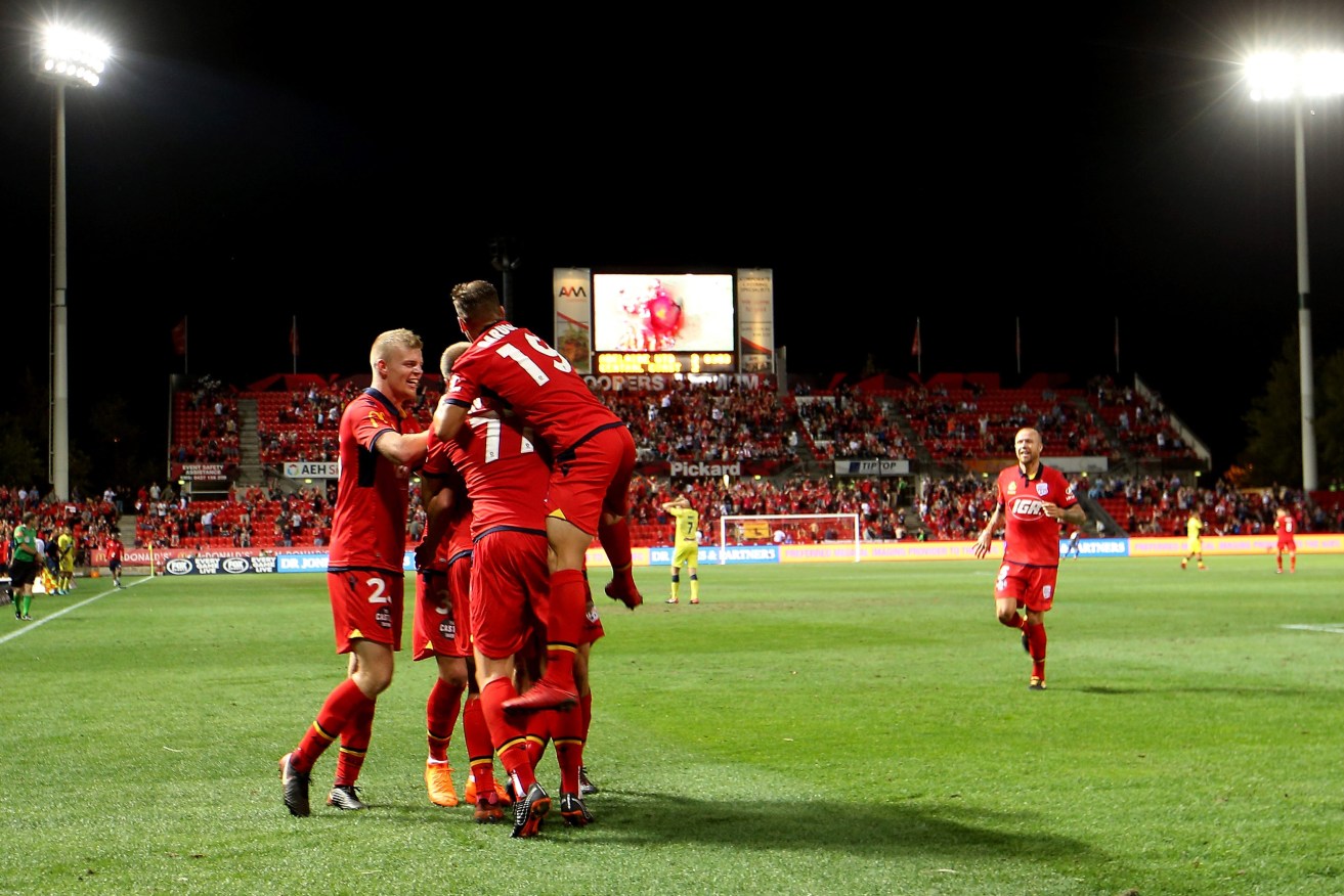 United players celebrate their second goal against the Central Coast Mariners. Photo: AAP/James Eslby
