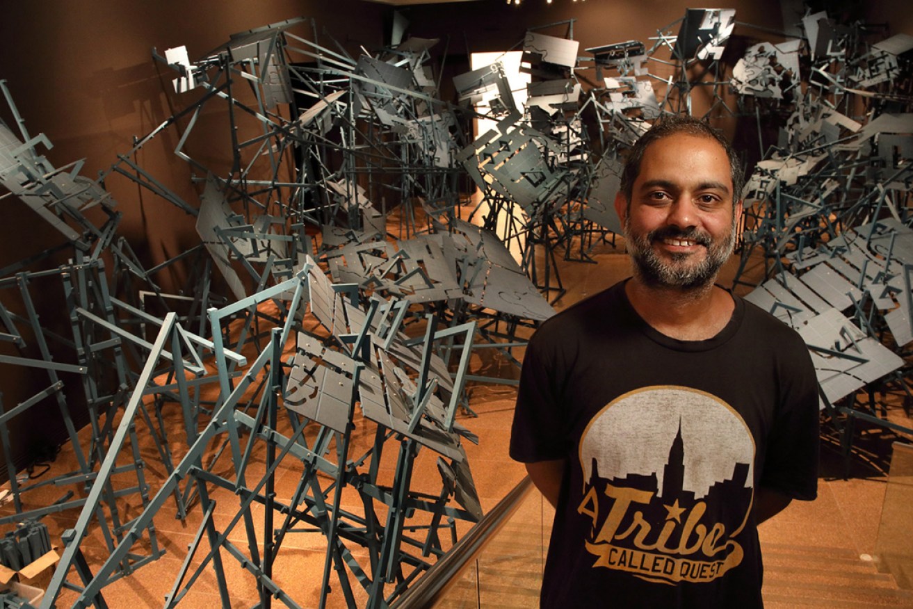 Roy Ananda with his Dungeons & Dragons-inspired work. Photo: Tony Lewis / InDaily