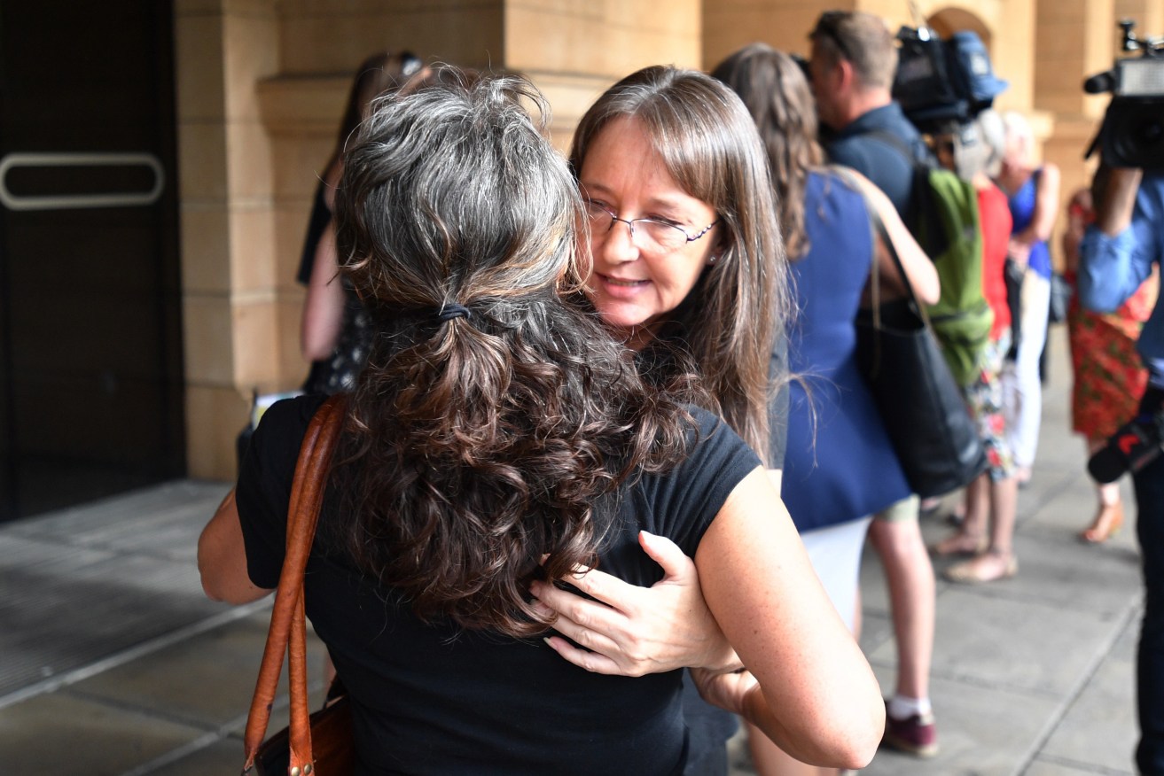 Jenny Hallam with supporters outside the District Court in Adelaide today. Photo: AAP/David Mariuz