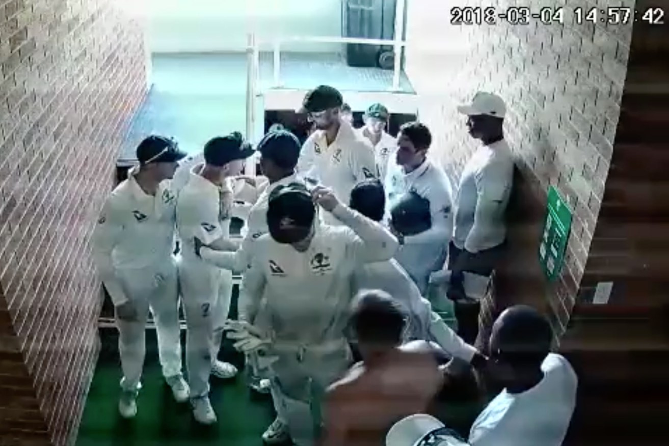 A still image from a video of Australian team members restraining David Warner from getting to South African Quinton de Cock. Photo: AAP/Supplied/IOL