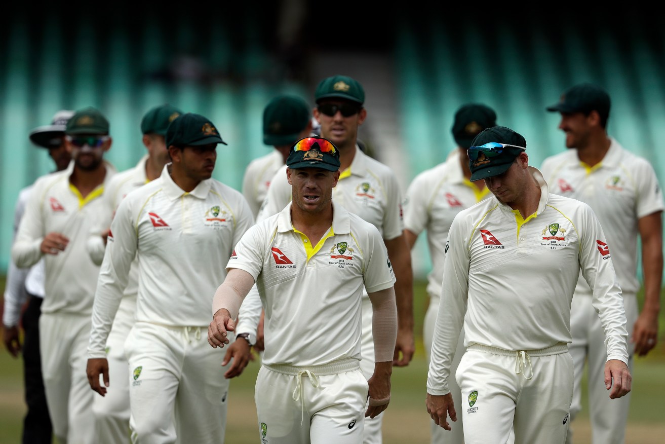 David Warner, centre, leaves the field in Durban surrounded by his teammates. Photo: AP Photo/Themba Hadebe