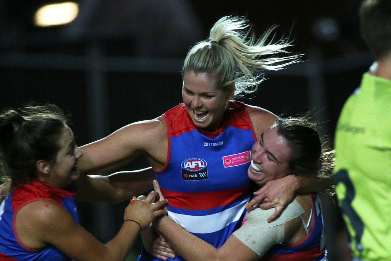 Katie Brennan celebrates her goal during the Round 7 AFLW match between the Bulldogs and the Demons. Photo: George Salpigtidis / AAP