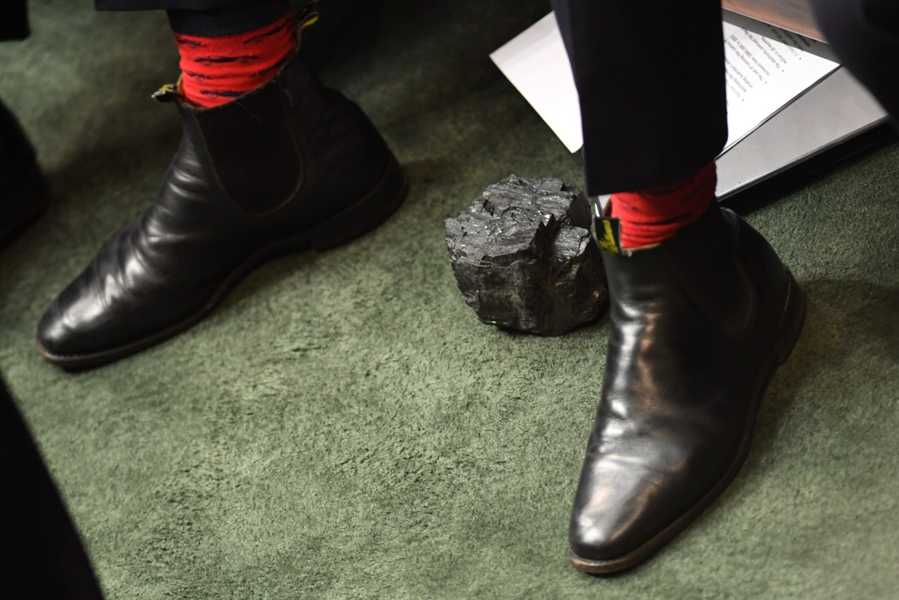 A piece of coal at the feet of then Deputy Prime Minister Barnaby Joyce during Question Time a year ago. Photo: AAP/Lukas Coch