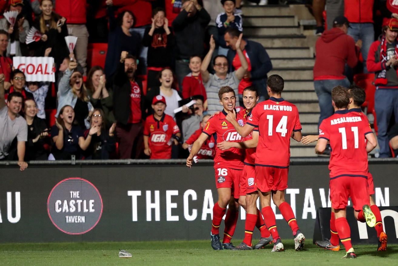 United's Nathan Konstandopoulos (left) celebrates after scoring on Friday. Photo: AAP/James Elsby