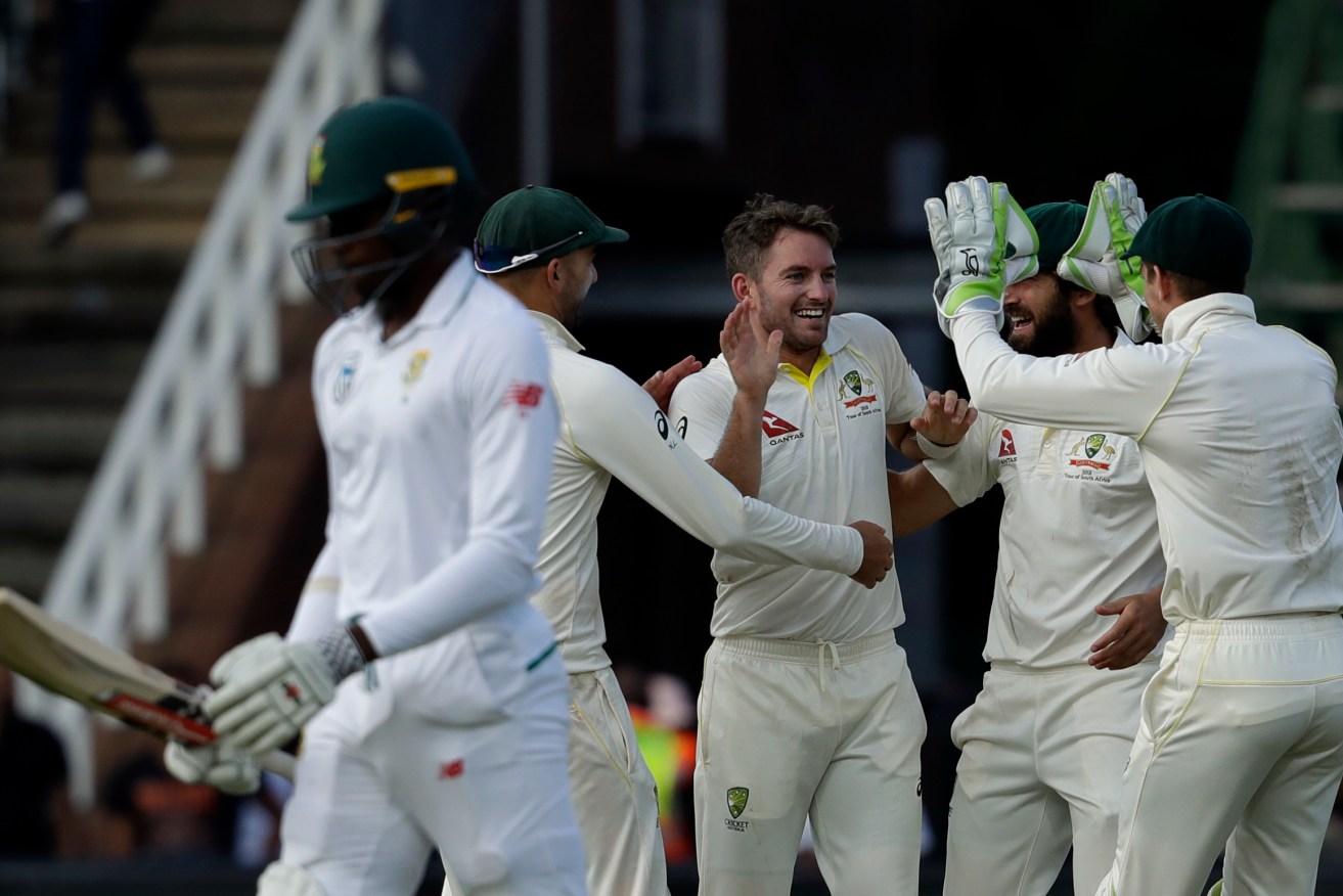 Chadd Sayers (centre) celebrates a wicket during his Test debut against South Africa. Photo: AP/Themba Hadebe