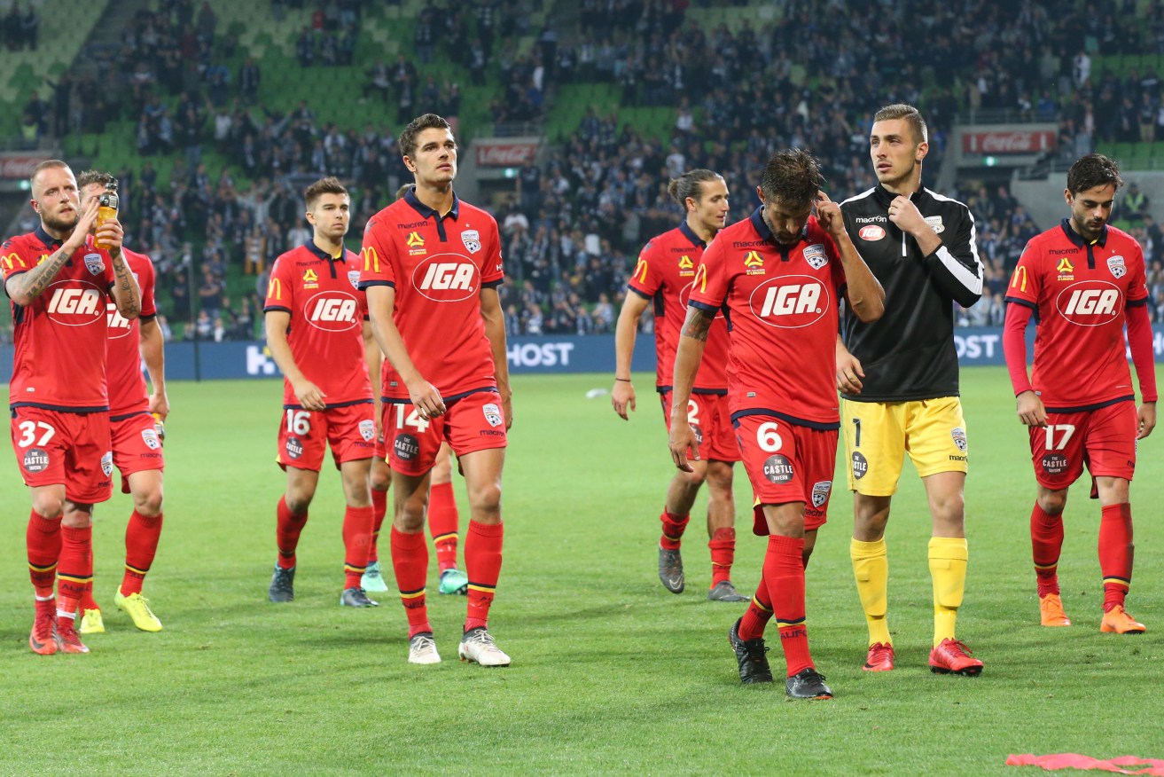 United players leave the field after another finals loss to Melbourne Victory. Photo: David Crosling / AAP