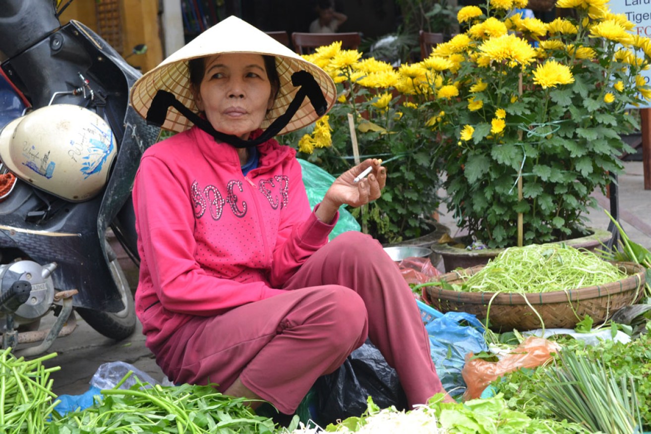 A woman sells produce at a food market in Ho Chi Minh City. Photo: Lucy Hughes Jones / AAP
