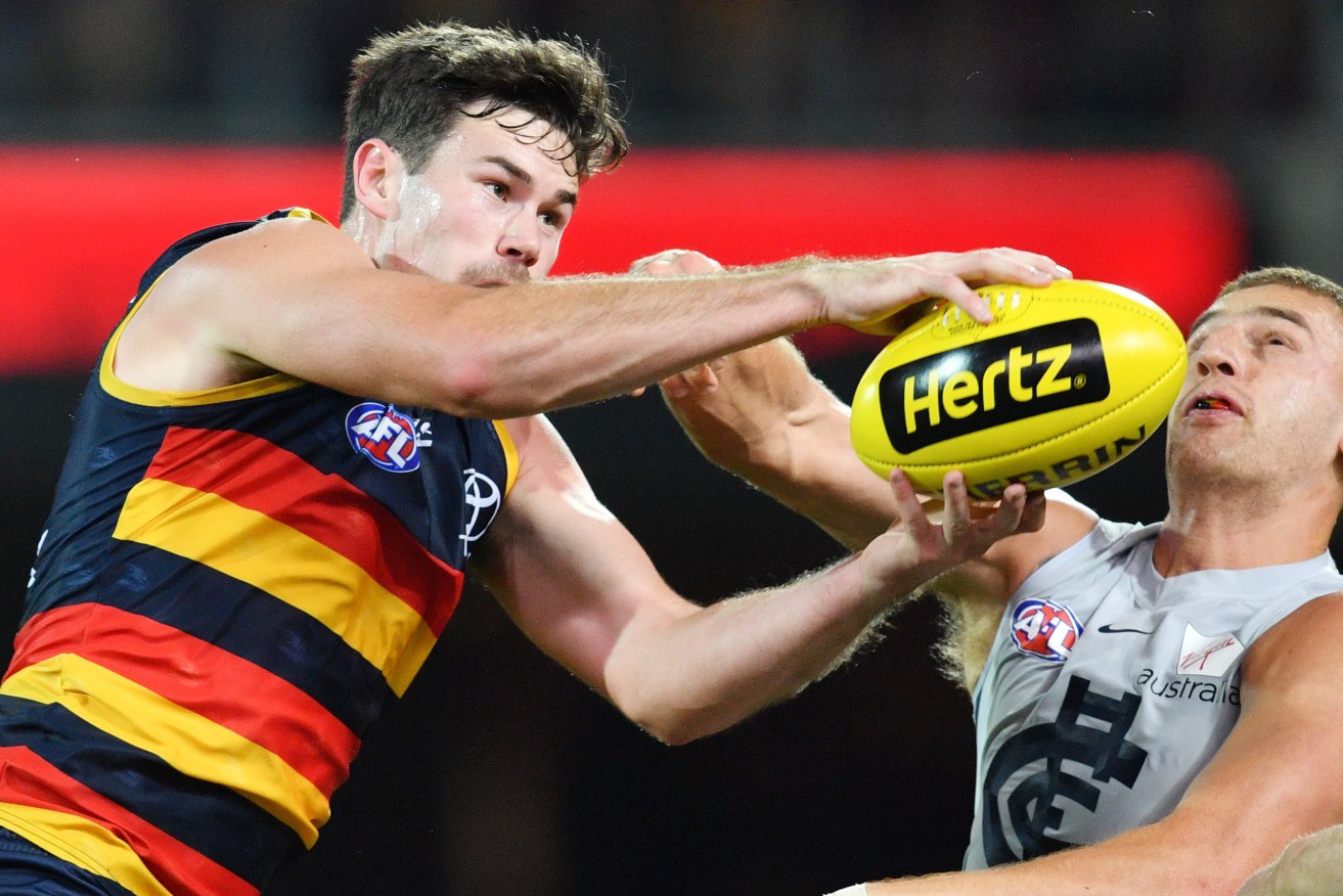 Mitch McGovern outmarks Liam Jones during Adelaide's comfortable win over Carlton. Photo: David Mariuz / AAP
