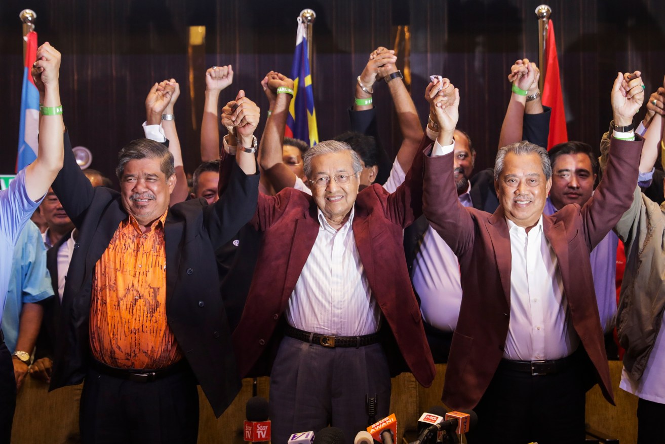 Mahathir Mohamad (centre), former Malaysian prime minister, celebrates with party supporters. Photo: EPA/Fazry Ismail