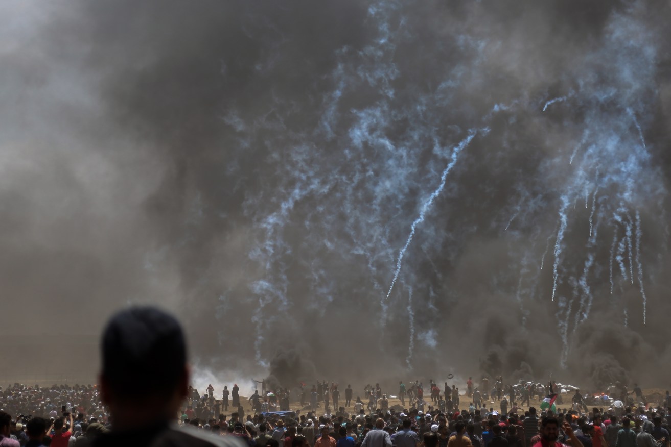 Tear-gas fired by Israeli troops rains down on  Palestinian protesters during  protests near the border with Israel in the northern Gaza Strip. Photo: EPA/Haitham Imad