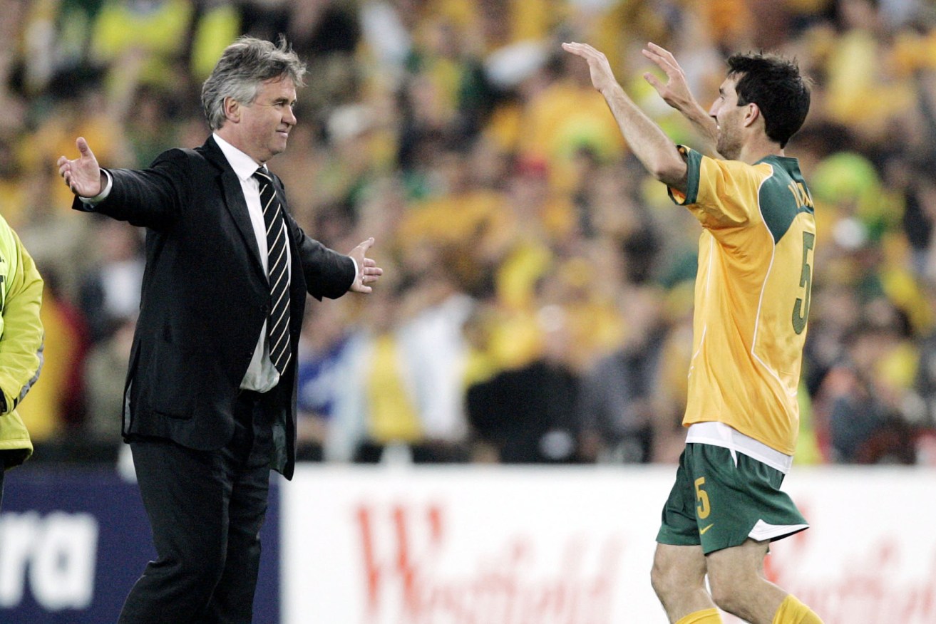 Australian coach Guus Hiddink from the Netherlands celebrates with Tony Vidmar (5) after their second leg World Cup qualifier against Uruguay at Sydney's Olympic Stadium, Wednesday, Nov. 16, 2005. Australia defeated Uruguay on penalties to book a World Cup soccer finals berth for the first time since 1974. (AP Photo/Mark Baker)
