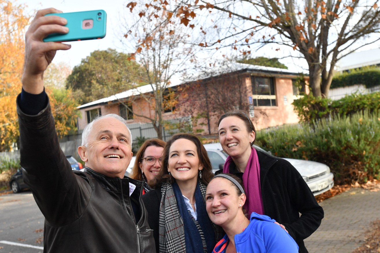 Georgina Downer gamely smiles for a selfie with PM Malcolm Turnbull and locals while campaigning in Mayo this month. Photo: David Mariuz / AAP