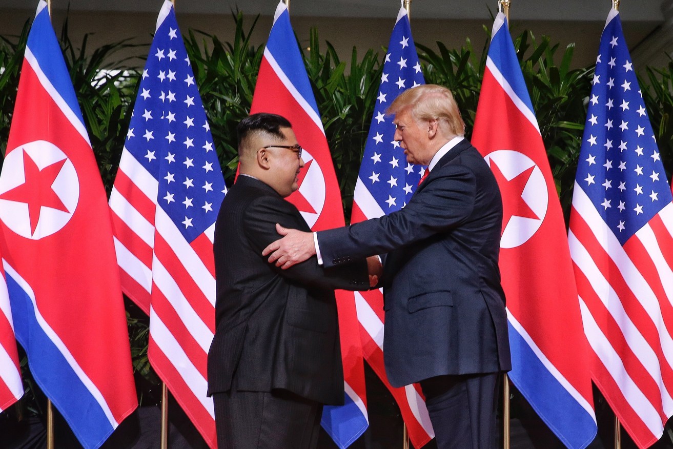 US President Donald Trump and North Korean leader Kim Jong-un shake hands at the start of a historic summit at Capella Hotel on Sentosa Island, Singapore. Photo: EPA/Kevin Lim/The Straits Times/SPH Singapore