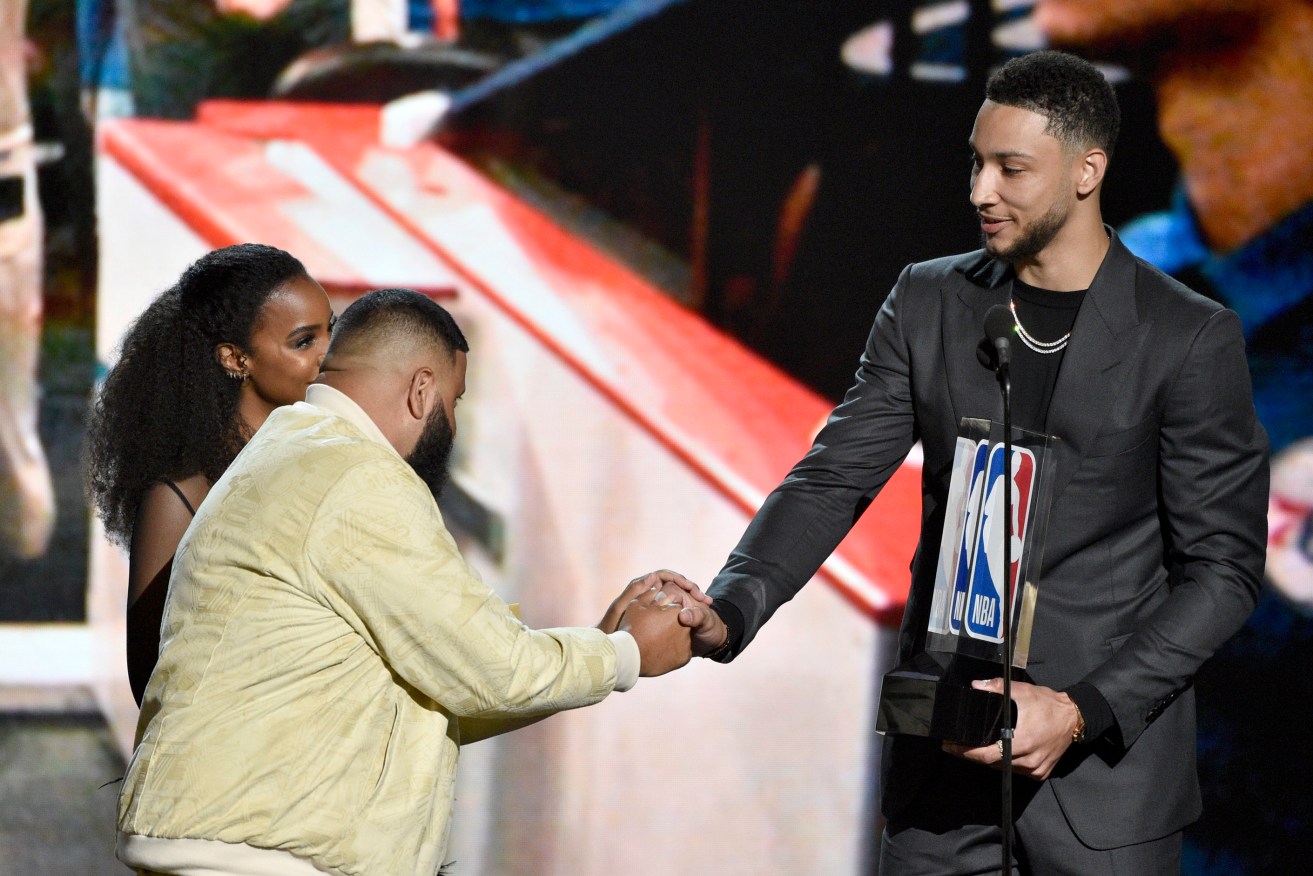 Ben Simmons is presented with his award by Kelly Rowland and DJ Khaled. Photo: Chris Pizzello/Invision/AP