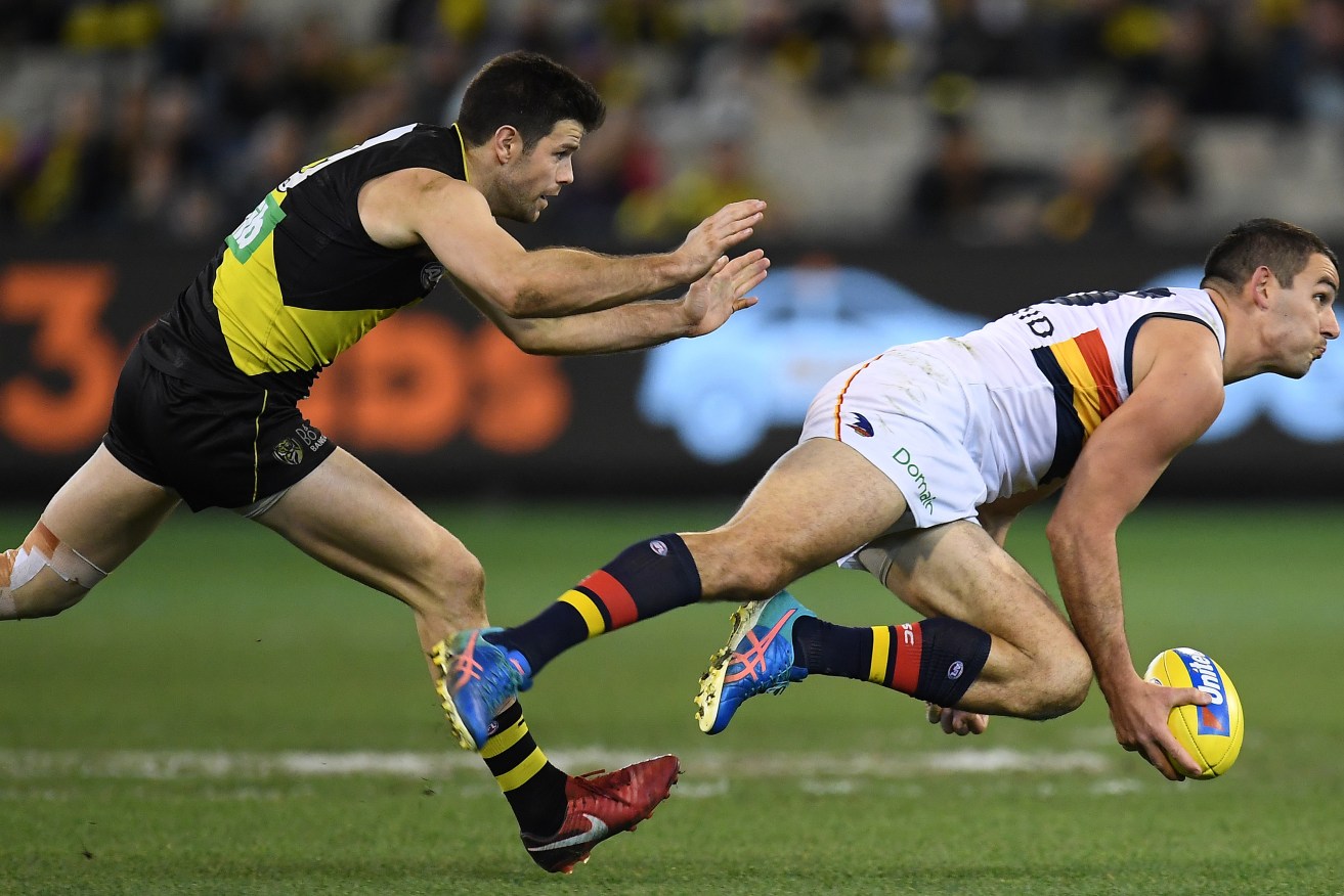 Trent Cotchin and Tex Walker provide a striking impression of the weekend's game. Photo: Julian Smith / AAP