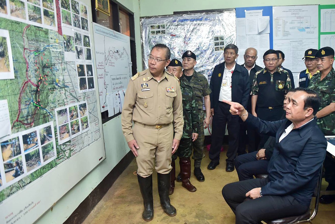 Thai Prime Minister Prayut Chan-o-cha (right) being briefed about the rescue operation. Photo: EPA/Supplied by Thai Government