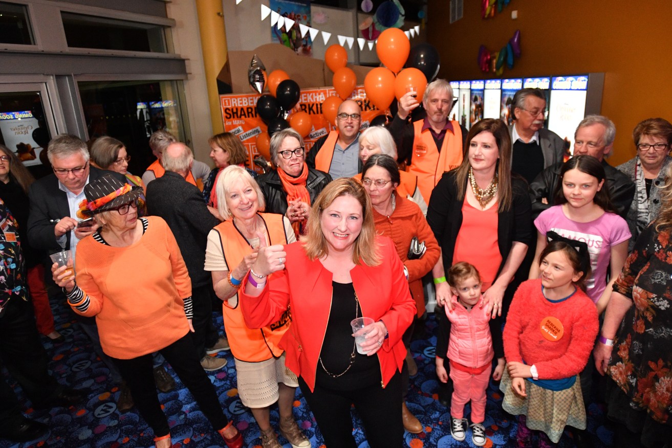Rebekha Sharkie (centre) celebrates with supporters at the Wallis cinema complex in Mt Barker. Photo: AAP/David Mariuz