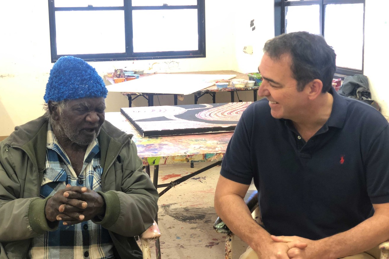 Premier Steven Marshall speaking to artist Pepai Jangala Caroll in Ernabella during his visit to the APY Lands. Photo: Supplied