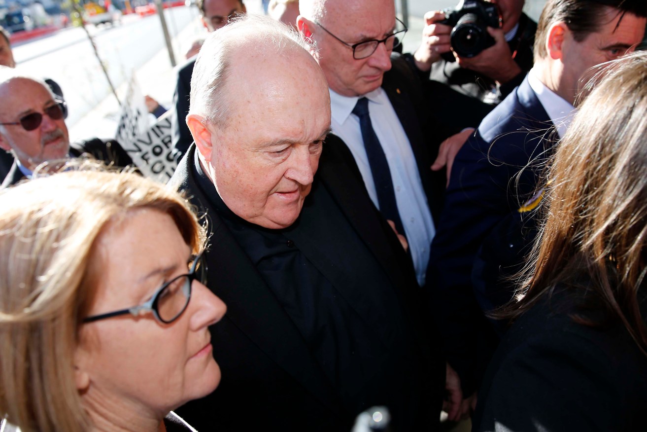 Former Adelaide Archbishop Philip Wilson (centre)
arrives at Newcastle Local Court today. Photo: AAP/Darren Pateman