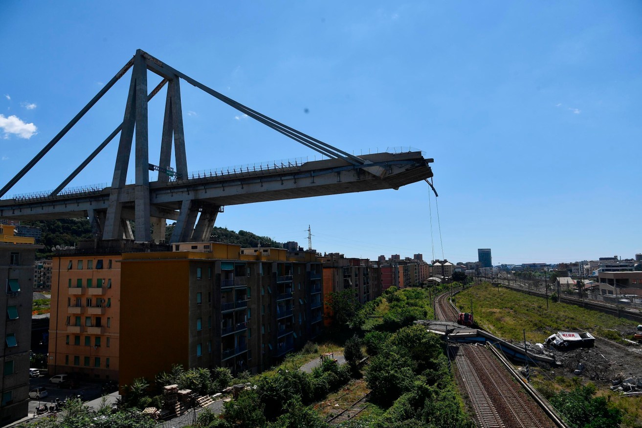 Evacuated houses in the shadows of the collapsed Morandi highway bridge in Genoa. Photo: AP/Nicola Marfisi