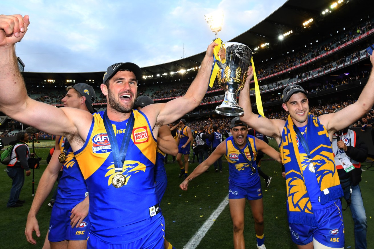 Jack Darling and Dom Sheed hold the premiership trophy. Photo: Julian Smith / AAP