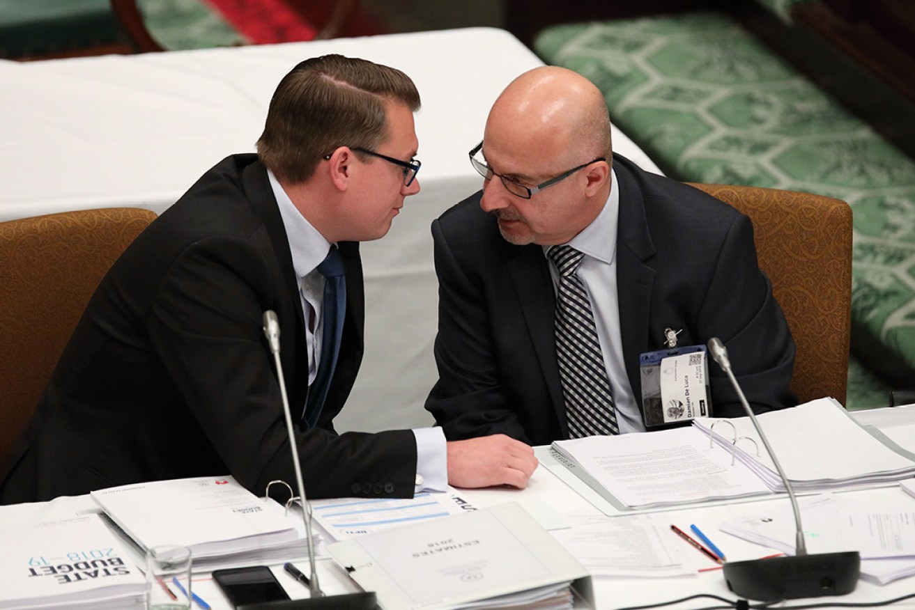 Stephan Knoll consults with Renewal SA's acting chief executive Damian De Luca in estimates today. Photo: Tony Lewis / InDaily