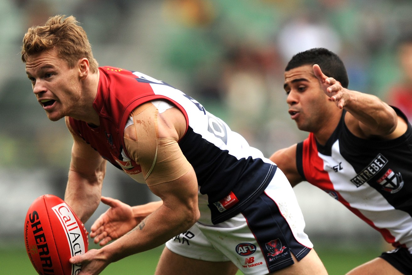 Colin Sylvia (left) in his Melbourne playing days. Photo: AAP/Joe Castro