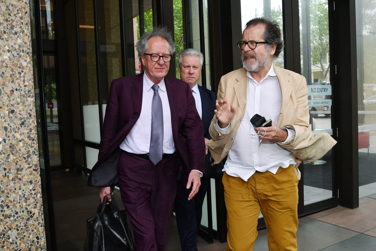 Neil Armfield (right) and  Geoffrey Rush outside the Federal Court in Sydney. Photo: AAP/Brendan Esposito