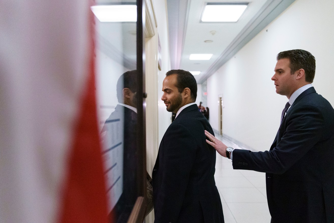 George Papadopoulos, (left) the former Trump campaign adviser who triggered the Russia investigation, is guided as he arrives for his first appearance before congressional investigators on Capitol Hill. Photo: AP/Carolyn Kaster