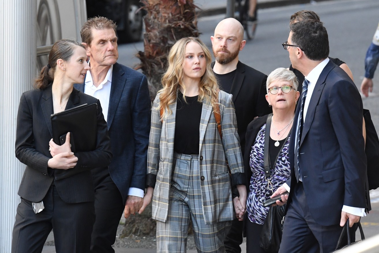 Actor Eryn Jean Norvill (centre) arrives the Federal Court before giving evidence in the Geoffrey Rush defamation case. Photo: AAP/Petter Rae