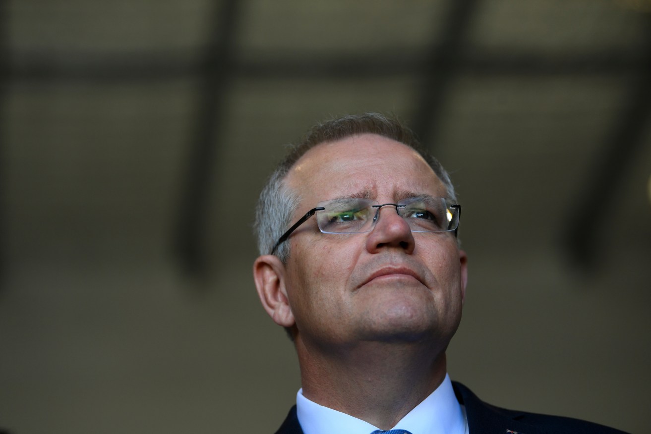 Prime Minister Scott Morrison says he is easing visa restrictions so farmers aren't left "high and dry" by a lack of labour. Photo: AAP/Lukas Coch
