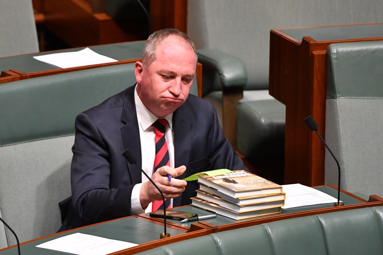 Barnaby Joyce signing copies of his book in Parliament this week. Photo: AAP/Mick Tsikas