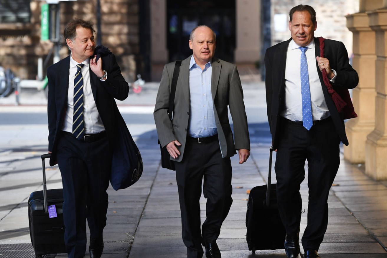 Jurgen Michaelis (centre) attending the District Court with his legal team earlier this year. Photo: Mark Brake / AAP