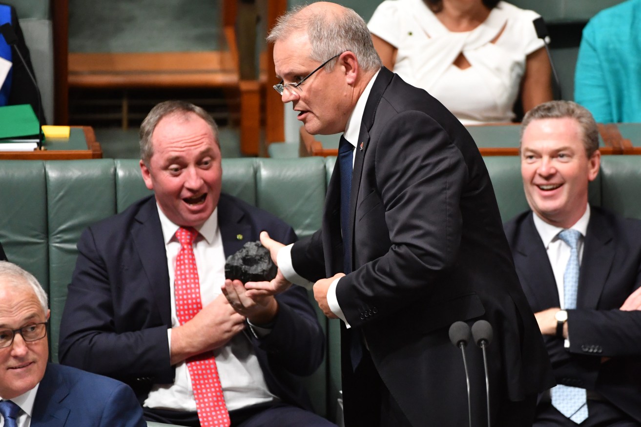 Then-Treasurer Scott Morrison with a lump of coal and Nationals leader Barnaby Joyce in 2017 after SA's blackout. Photo: Mick Tsikas / AAP