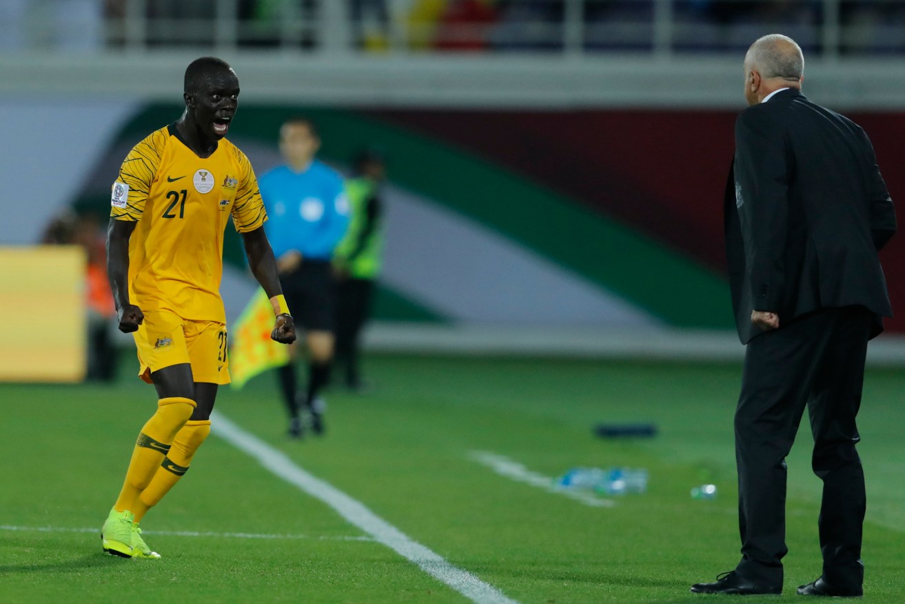 Awer Mabil celebrates with Graham Arnold after scoring against Syria. Photo: AP/Hassan Ammar