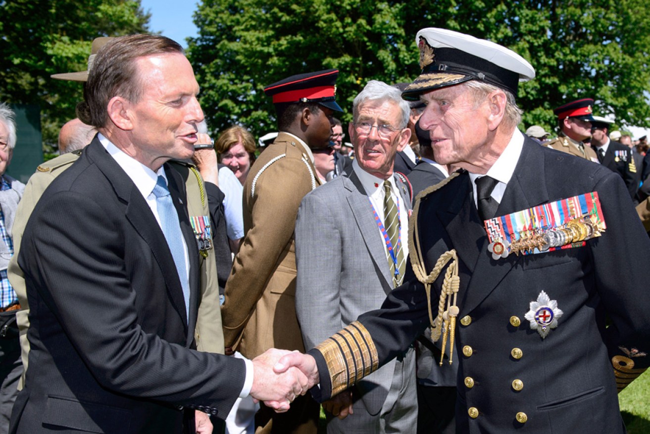 The SA Labor Party has compared a push for the reinstatement of appointing QCs to Tony Abbott's politically disastrous move to knight Prince Philip in 2015. Photo: Abbott (left) greets Prince Philip following a British D-Day commemoration ceremony in 2014. AAP / Leon Neal